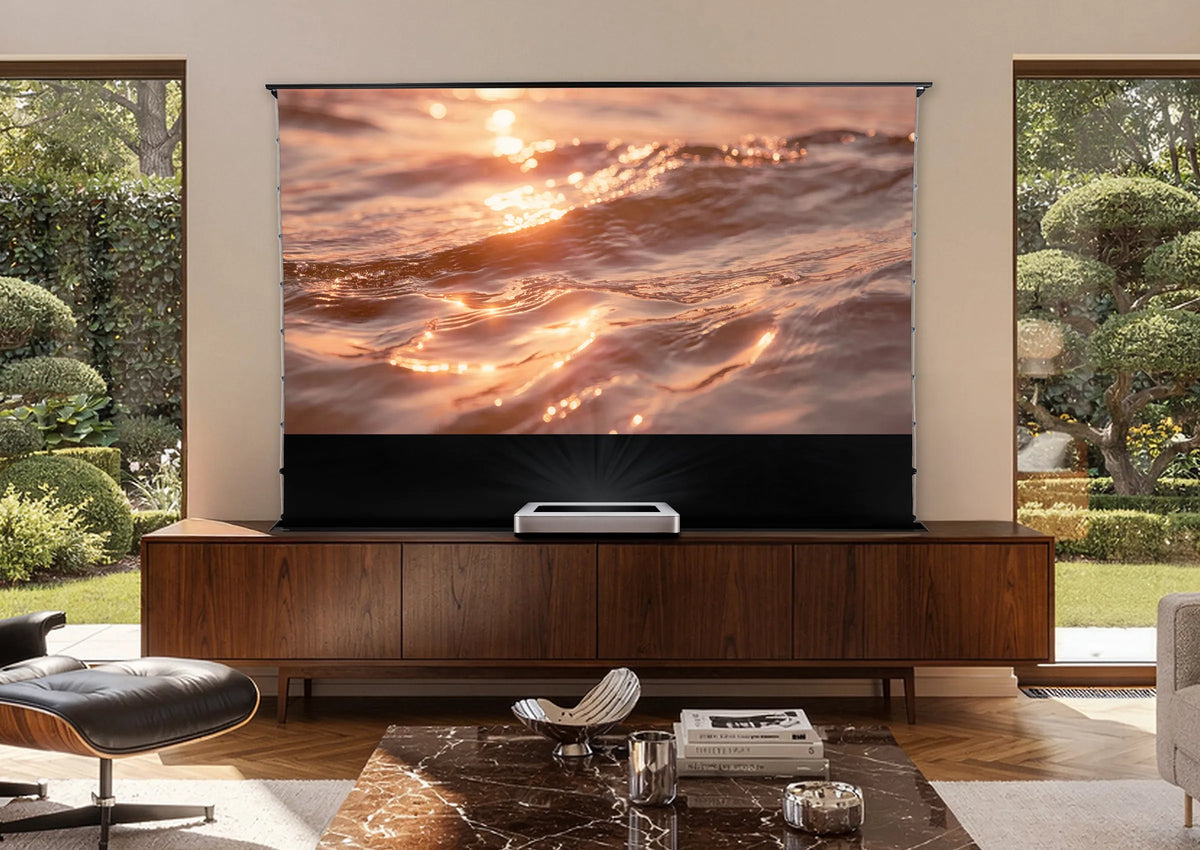 Modern home cinema with a V2.0 floor-rising screen built into a piece of furniture and a UST projector integrated into the living room with daylight.