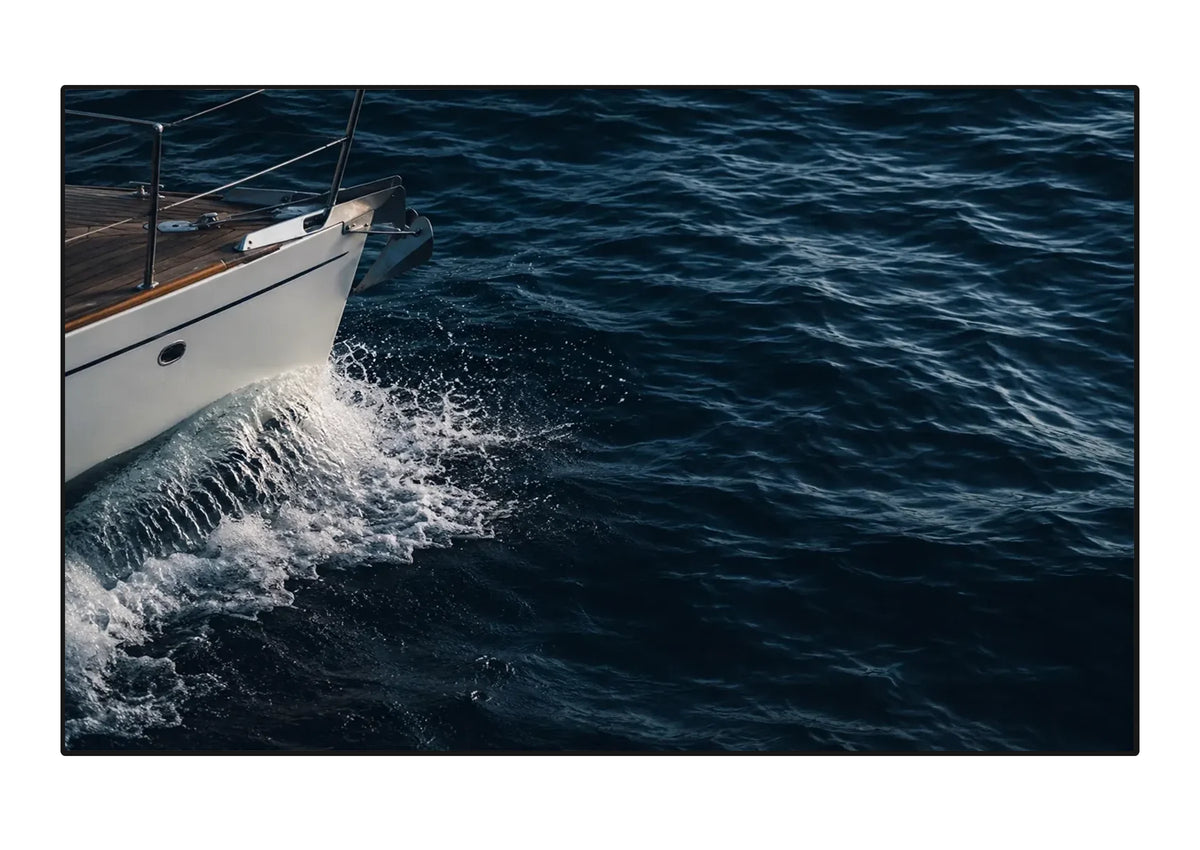 Frontal view of the celexon SOUNDVISION Premium Plus Frame Screen, with a projection of water and a boat