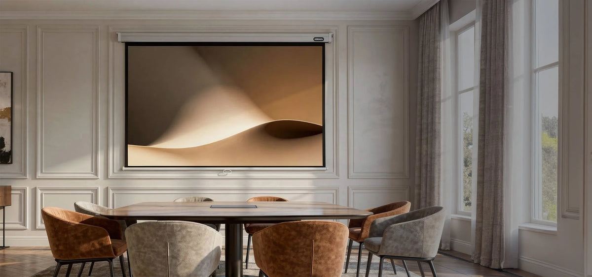 The image shows an elegant, classically furnished conference room with wall paneling, a large table, and upholstered chairs, at the center of which a celexon Manual Professional projector screen displays a calm, abstract projection of softly flowing, sand-colored shapes.