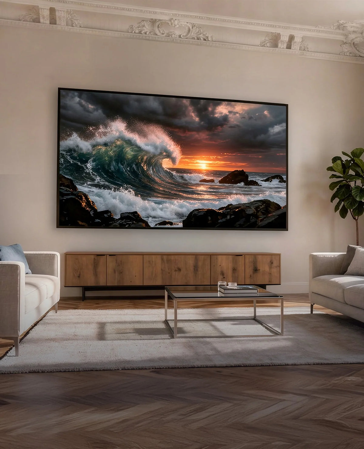 The image shows an elegant living room with two sofas and a celexon HomeCinema High Contrast Frame Projector Screen – Dynamic Slate ALR, displaying a powerful ocean wave at sunset.