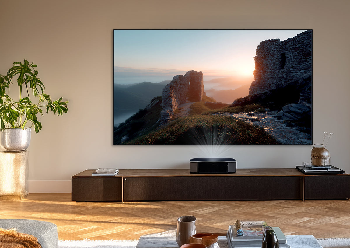 Modern living room with an ultra-short-throw projector projecting a large-format, atmospheric landscape with castle ruins at sunrise onto the celexon CLR HomeCinema Performance UST high-contrast fixed-frame projector screen.