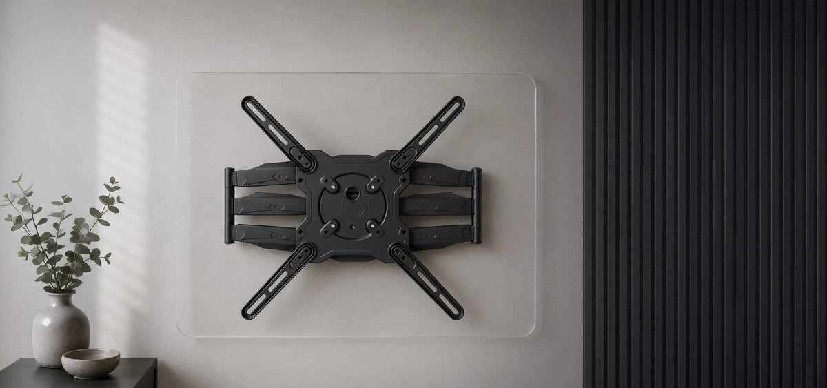 A minimalist product presentation of a TV wall mount positioned beneath a transparent acrylic panel with rounded corners. Front view with the central VESA mounting interface and the entire wall mount fully visible. A bright, modern wall, subtle home accessories, and soft natural daylight create a premium living atmosphere with a clear focus on the product.