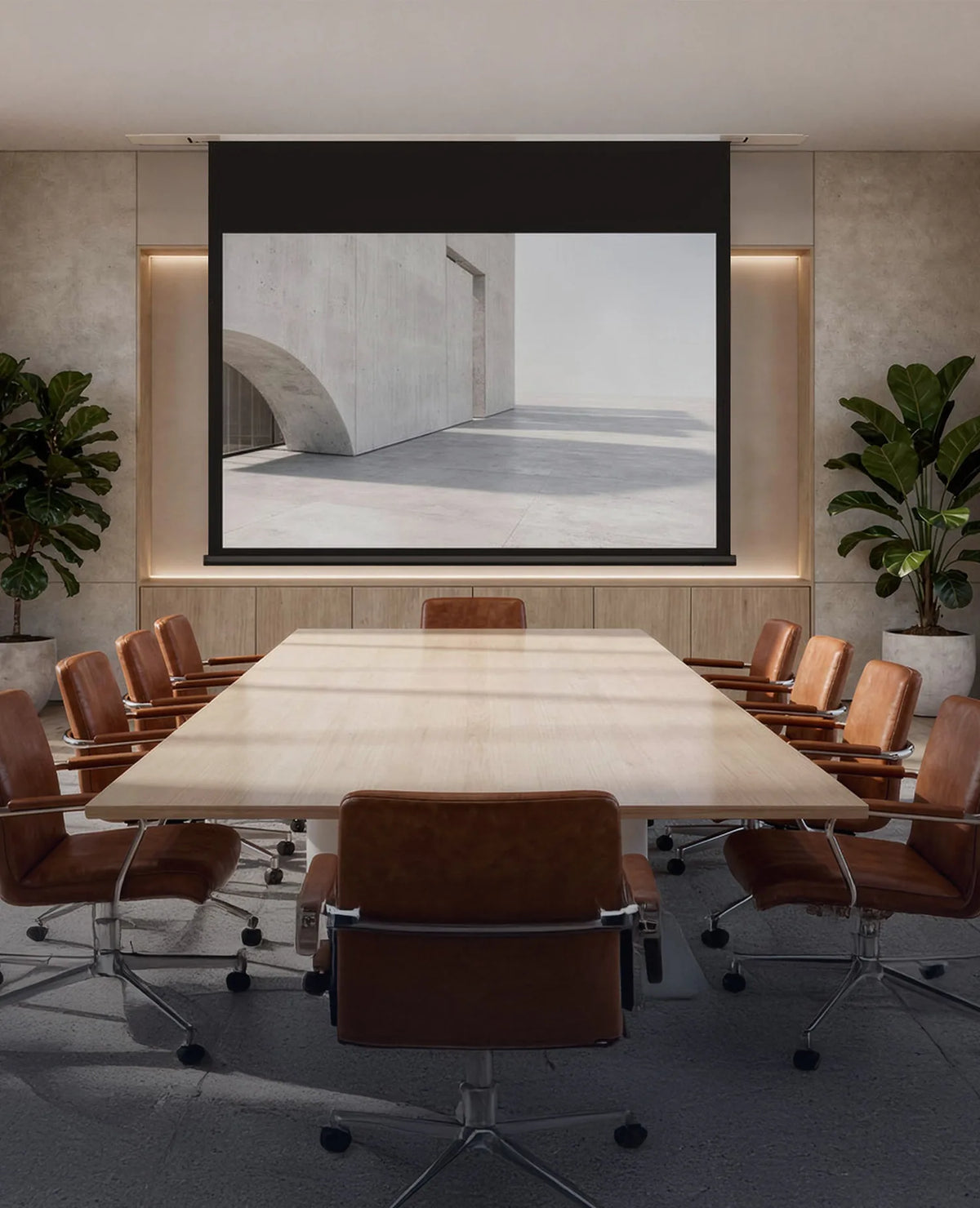 The image shows an elegant, modernly designed conference room with a large wooden table and brown leather swivel chairs, in which a celexon ceiling recessed electric projector screen Expert displays a minimalist architectural scene of light-colored concrete with clean lines and a calm, reduced atmosphere.